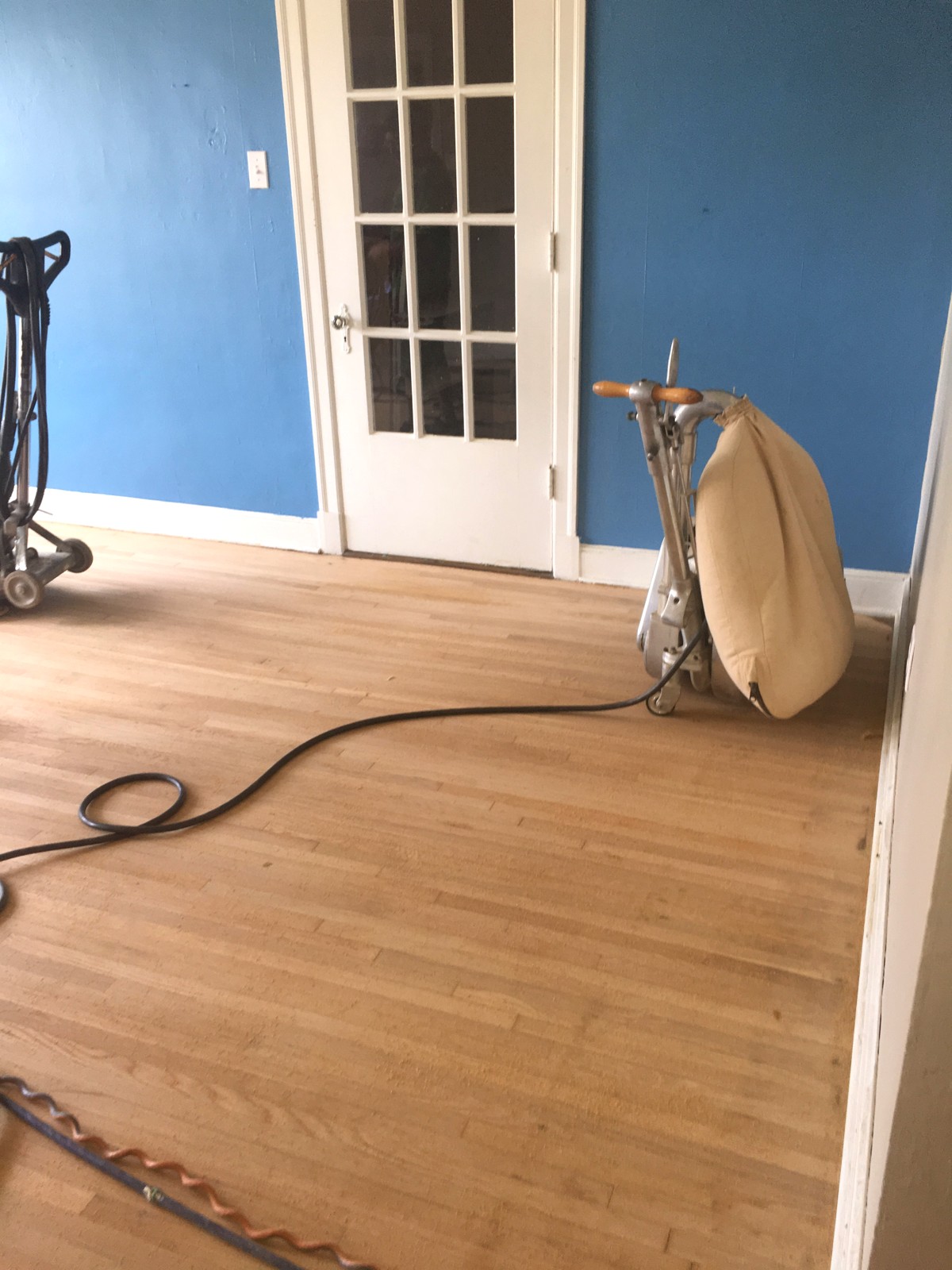 Hardwood floor being sanded and refinished